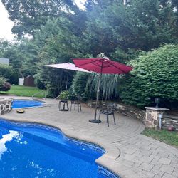 two outdoor patio umbrella with base, no tear, working 