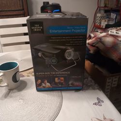 NWT SHARPER IMAGE MOVIE / VIDEO GAME PROJECTOR 