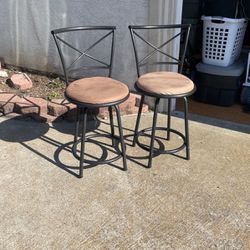 A pair of two swiveling stools