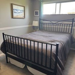 Queen wrought iron bed and clean mattress