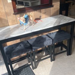 36 inch high table and three stools for $450