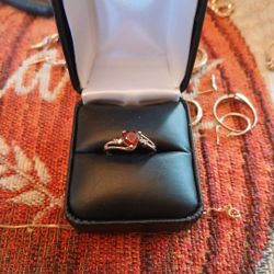 10k Yellow Gold Ring With Ruby Center. Has CZ.