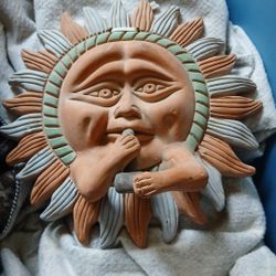 A sun smoking peace pipe
