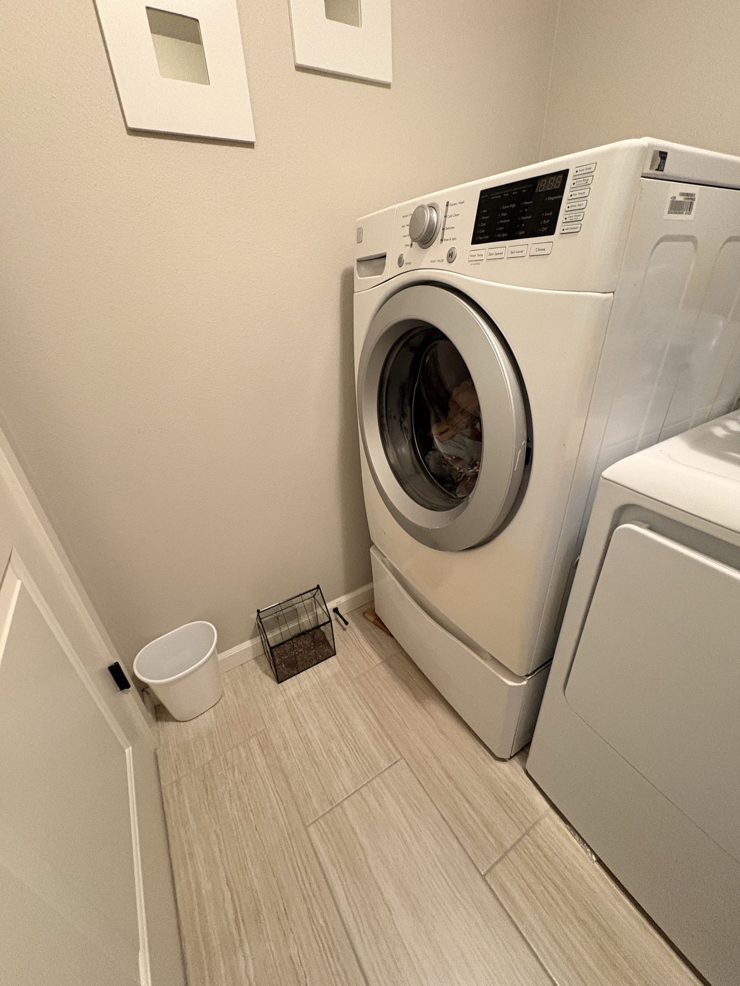 Kenmore white front load washer with pedestal.
