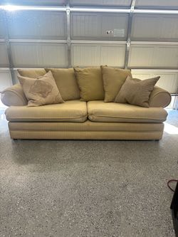 Upholstered three-seat pillow-back sofa light gold