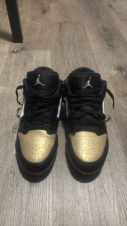 Gold, black , white Nike cleats