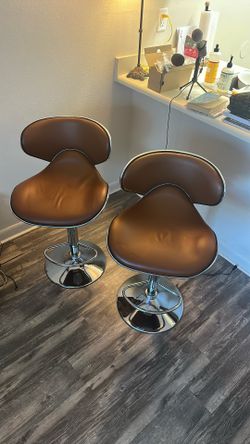 two brown bar stools