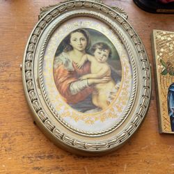 Bunch of religious statues and pictures and cross that’s an antique clock