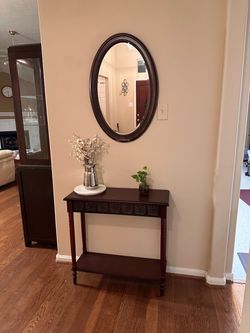 Dark Wood Console Table with Oval Mirror