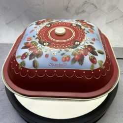 (1) Vintage style decorative tin box or container adorned with a strawberry pattern. illustrations of strawberries, blossoms, and leaves on a blue and