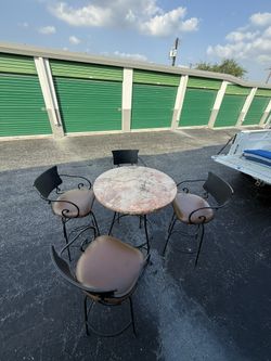 Wrought Iron, Marble Top Table With Four Swivel Bar Stools.