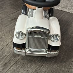 white retro-style ride-on push car toy for toddlers, featuring a working steering wheel for direction