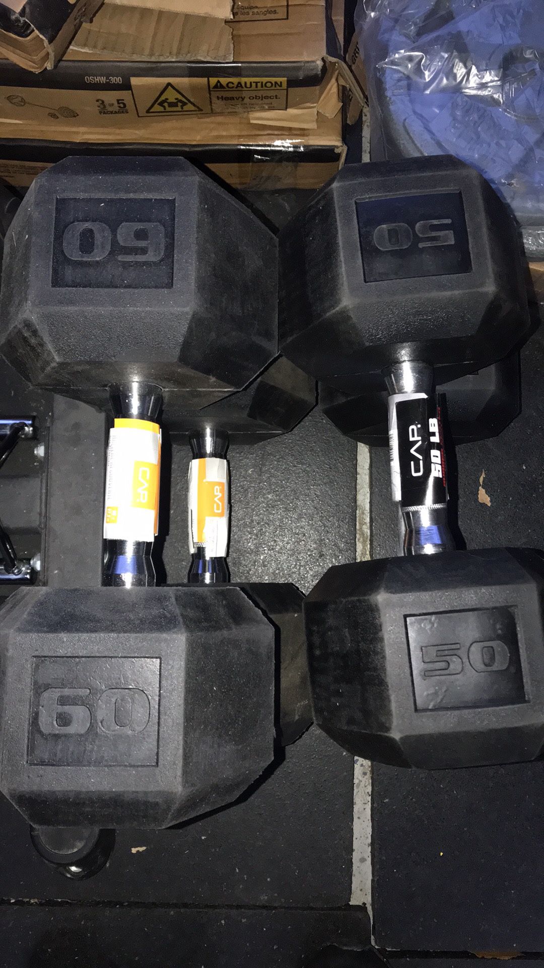 pair of 50 and 60 pound dumbbells