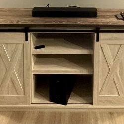 Farmhouse style stand with barn doors. 