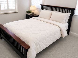 Queen sized black wood bed frame and mattress