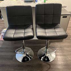 Two leather high chairs for bar or kitchen