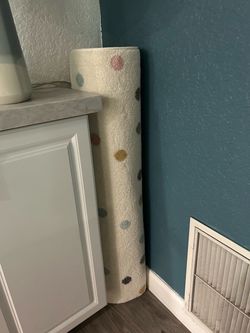 Cream Polka Dot Area Rug Rolled Up