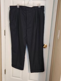 Mens Dress pants/slacks in a charcoal/dark gray color with thin pinstripes. 44" waist. 43" long (waist to hem).
Two buttons, hook and eye closure. (Ho