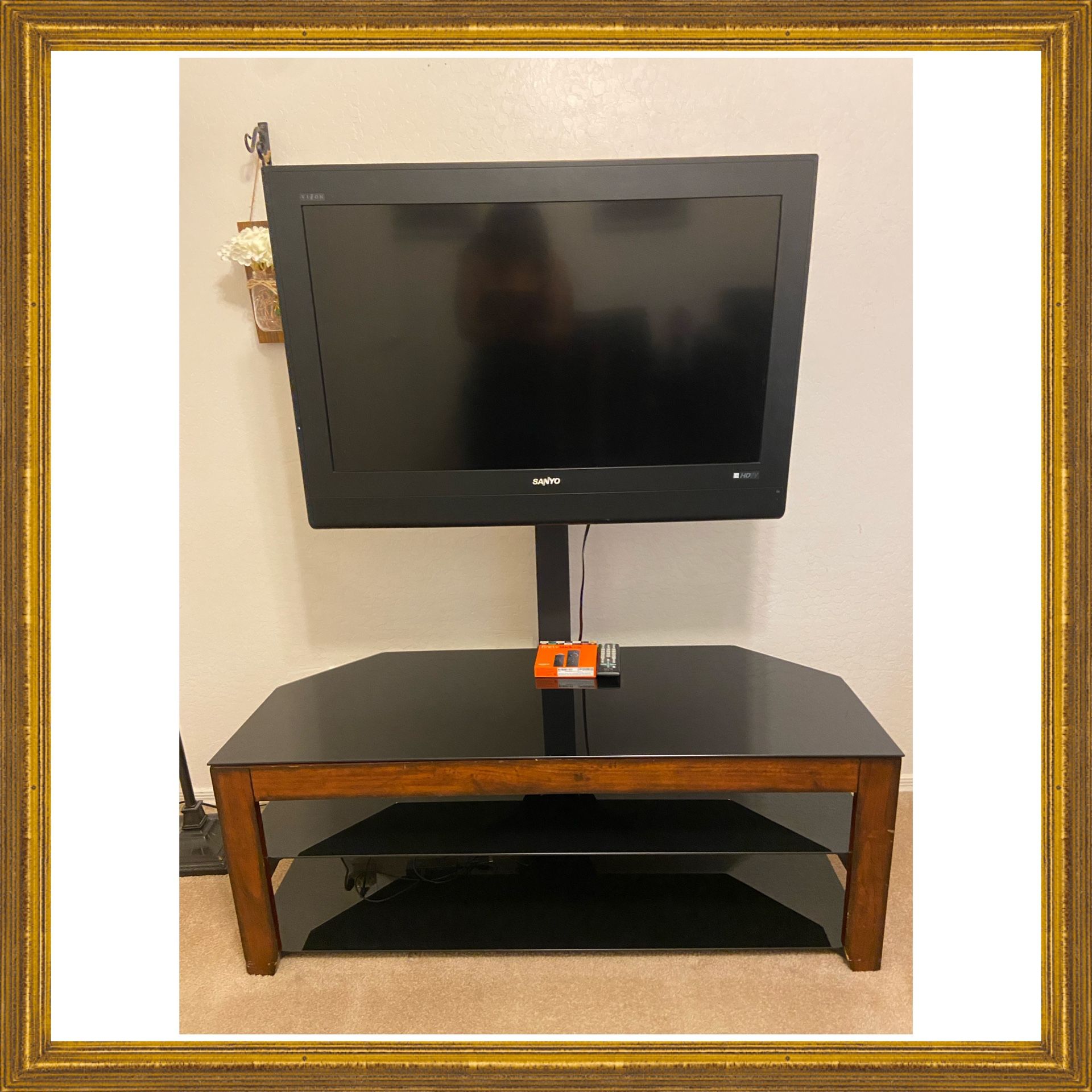 TV WITH  STAND .  32 INCH SANYO TV STAND HAS NEXK THAT HOLDS TV AND ROTATES LEFT TO RIGHT. STAND HAS 2 SHELVES.  