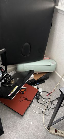 Cricut machine and heat press along with the rolls for it