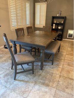 Wooden dining room table with chairs