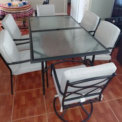 Clear Glass Patio table , with 6 chairs .