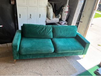 Forest green velvet sofa with gold legs
