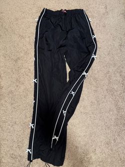 Black windbreaker pants with bows on the sides