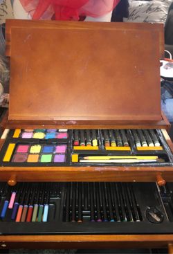 Art kit with easel and wood container/holder watercolor paints chocks markers colored pencils drawling. A couple of the screws need to be put back