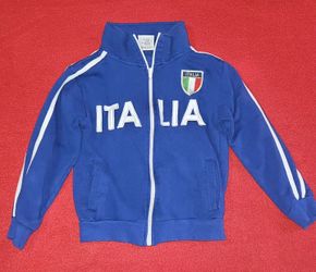 Italia Venice Collection Blue Track Jacket, featuring white zipper hardware, white sleeve piping, bold "ITALIA" chest lettering, and an Italian flag s