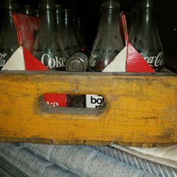 Vintage coke bottles and wooden case.