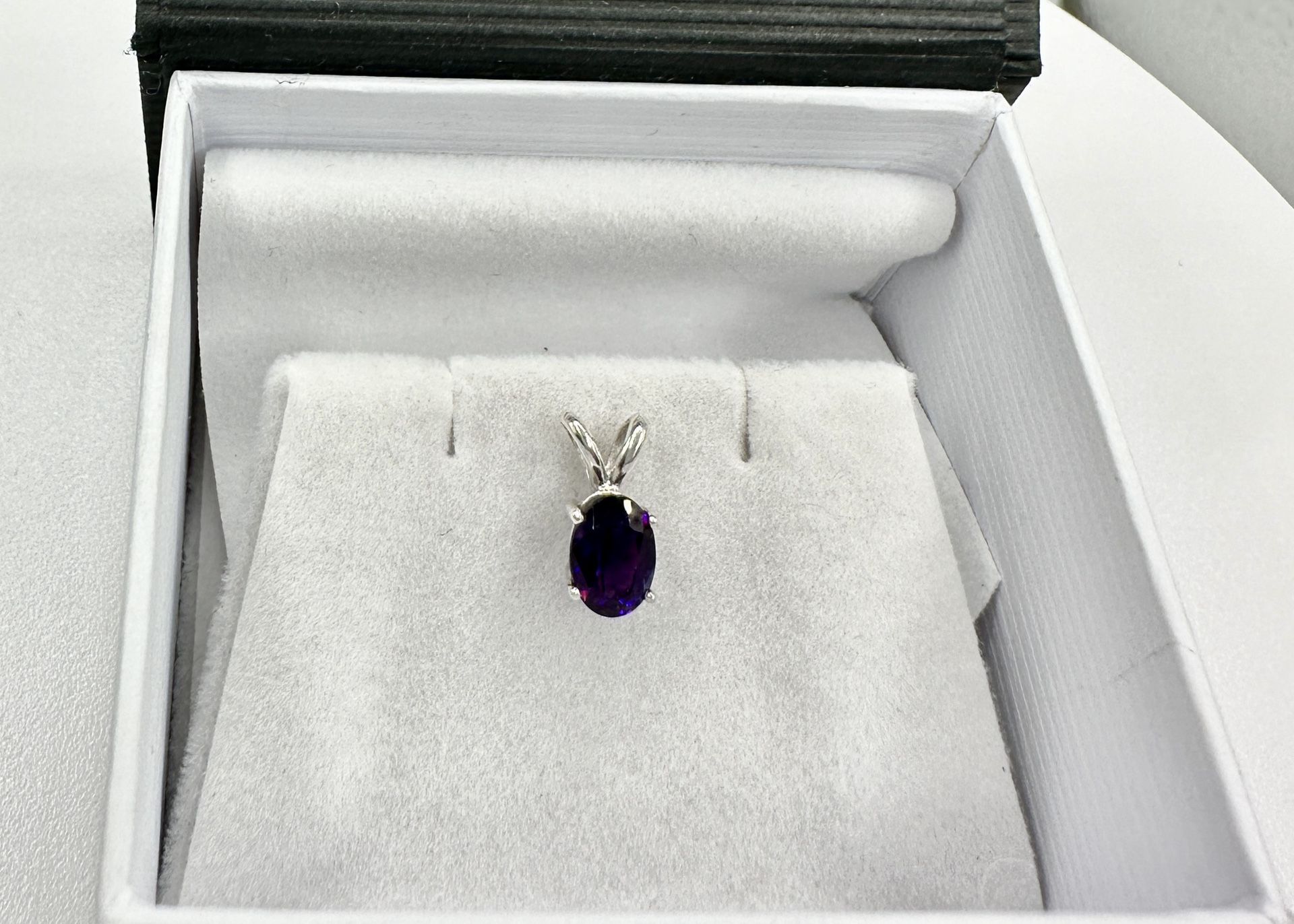 amethyst oval set in a sterling silver pendant
