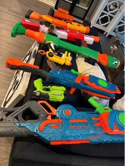 Nerf guns , laser tag guns, and game controller picture