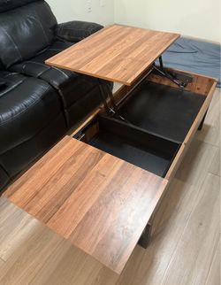 Height adjusting coffee table with storage space