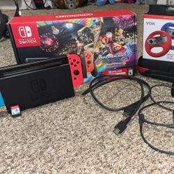 Nintendo Switch with Case, Pokemon Shield, and Racing Wheel