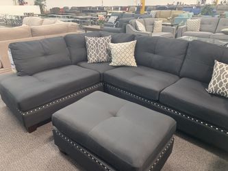 Black sectional sofa with nail heads