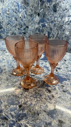 vintage Fostoria Monet Peach Water Goblet with a ribbed optic bowl and a faceted, star-like footed base