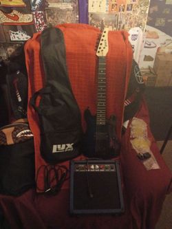 "Lyx" Pro guitar with case, extras, and "Lyx" Amplifier...