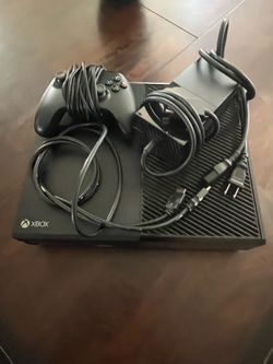 Xbox 1 with wired controller and power extension cords.