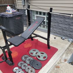 MARCY. BENCH WITH 120LBs  OF 1" HOLE PLATES. 
 2-25s. 4-10s.  4-5s. 4-2.5s. 
6' STRAIGHT BAR WITH COLLARS 
11525 S HALSTED DUNKIN DONUTS/ 7111.S WESTE