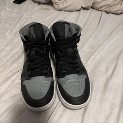 Grey and black mid top jordans
