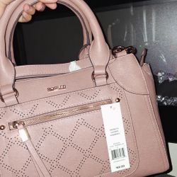 Pink leather bag with crossbody attachments 