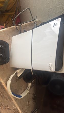 ps5 with two headsets and a controller