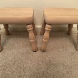 Two small, short unfinished solid wood milking stools