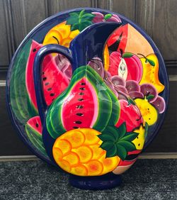 Decorative pitcher with a large platter