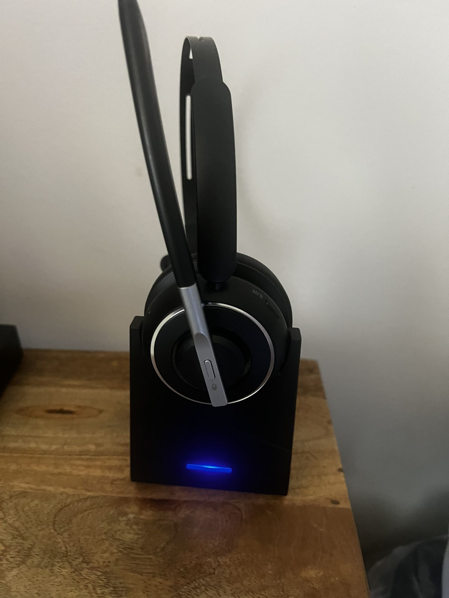 The image shows a PrancyBt Bluetooth Headset V5.2 Wireless AI Noise Cancelling KH120M with its charging base