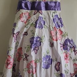 Girls fluffy summer floral dress size 5 by Little Miss Attitude with a large purple ribbon to tie a bow in the rear. There is minor scratches on the r