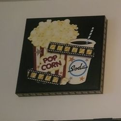 "Pop Corn & Soda" movie-themed wall art plaque or canvas, which is a popular type of home decor for media or theater rooms.