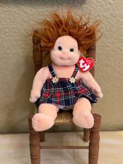 This is a Ty Beanie Kid "Ginger" doll featuring red hair and a plaid dress