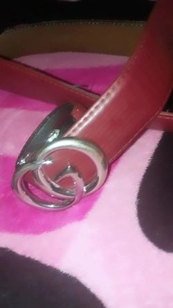 red leather belt with a silver-tone interlocking double-G logo buckle